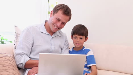 Father-and-son-with-laptop-in-the-living-room