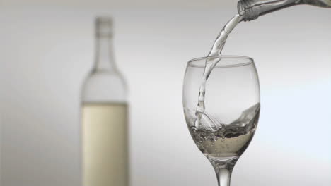 White-wine-flowing-in-super-slow-motion-from-a-bottle