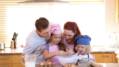 Little-girl-breaking-eggs-with-her-family