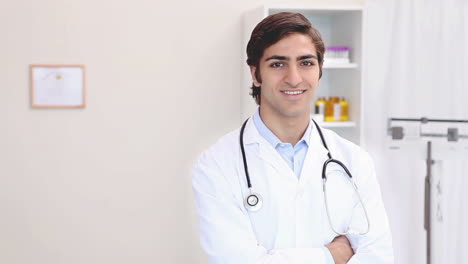 A-smiling-doctor-standing-in-his-office