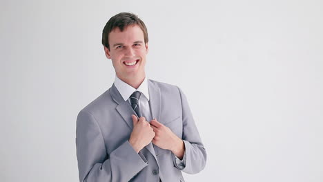 Smiling-businessman-wearing-his-jacket