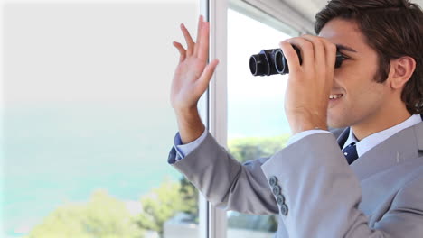 Businessman-businessman-looking-through-binoculars-while-waving