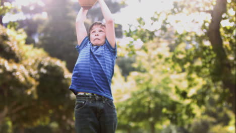 Child-playing-in-slow-motion-with-a-rugby-ball