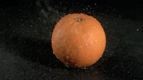 Water-raining-on-orange-in-super-slow-motion