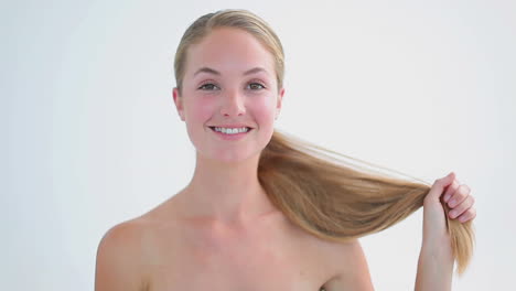 Smiling-woman-brushing-her-fair-hair
