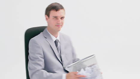 Businessman-sitting-while-holding-a-wastebasket