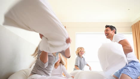 Young-family-having-a-pillow-fight