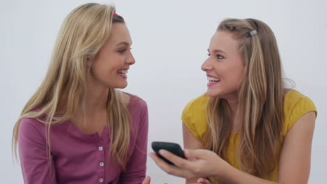 Two-friends-laughing-after-a-phone-call