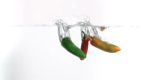 Chilies-falling-into-water-in-super-slow-motion
