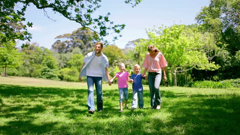 Family-walking-together-in-the-park-as-the-father-points-to-something