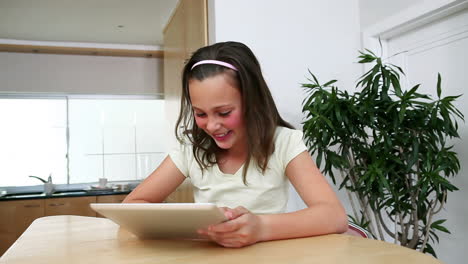 Girl-with-a-tablet-computer-in-the-kitchen