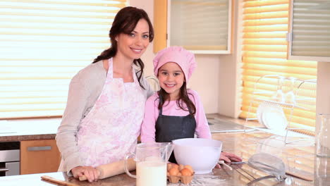 Smiling-mother-and-daughter-standing-upright