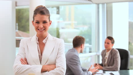 Smiling-businesswoman-standing-upright