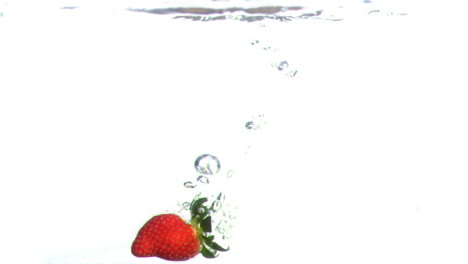 Strawberry-falling-into-water-in-super-slow-motion