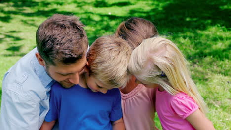 Family-posing-for-a-photo-before-looking-at-the-photo-gallery-in-the-camera