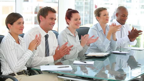 Clapping-business-team-sitting-together