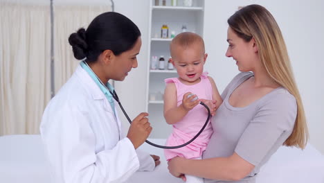 Baby-playing-with-the-doctors-stethoscope