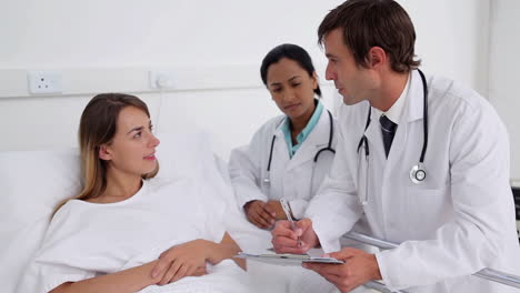 Doctor-talking-to-a-patient-and-then-smile-to-the-camera