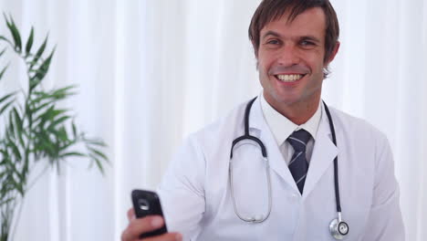 Smiling-doctor-sending-a-text-message