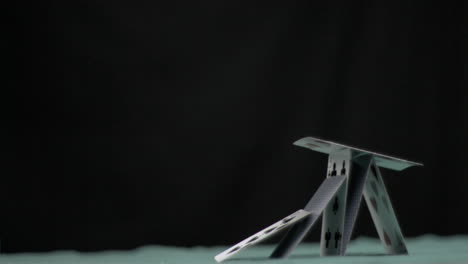 Pyramid-of-cards-collapsing-in-super-slow-motion