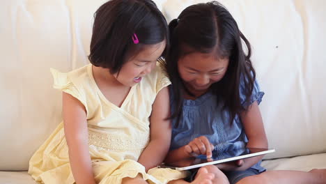 Two-children-using-a-tablet-computer-together