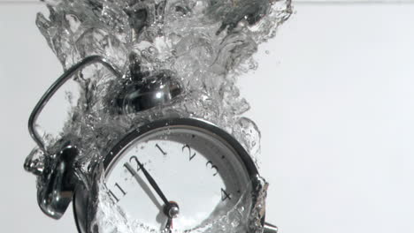 Alarm-clock-in-super-slow-motion-falling-in-the-water