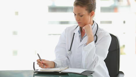 Medical-professional-taking-notes