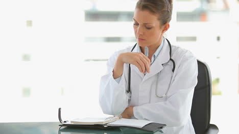 Medical-doctor-writing-in-her-journal