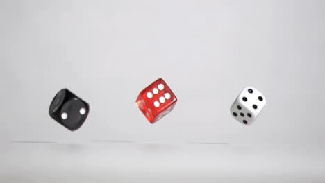 Three-black-red-white-dices-in-a-super-slow-motion-rebonding-