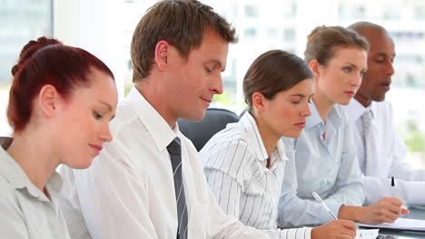 Equipo-De-Negocios-Sentado-En-Una-Sala-De-Conferencias