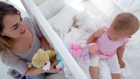 Mother-playing-with-her-baby-with-dolls