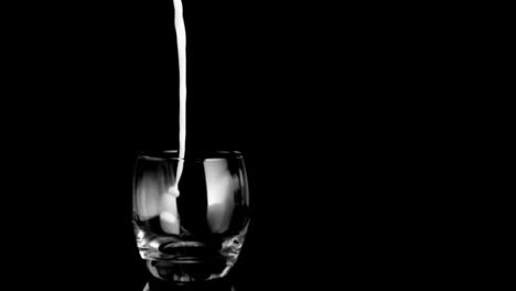 Glass-in-super-slow-motion-being-filled-by-milk