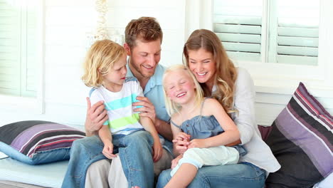 Parents-bouncing-their-daughters-on-their-laps