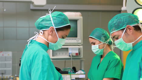 Side-view-of-a-surgical-team-operating