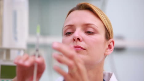 Female-doctor-holding-a-syringe-in-her-hand