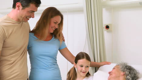 Family-standing-together-around-a-hospital-bed