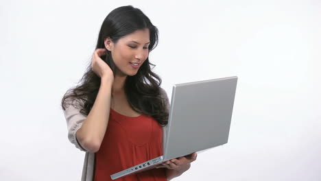Woman-using-a-laptop-while-holding-it