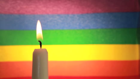 Candle-against-rainbow-flag