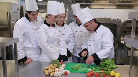 Head-chef-is-teaching-how-to-slice-vegetables