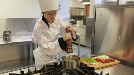 Cook-tasting-a-soup-and-adding-pepper