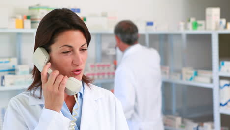 Female-pharmacist-phoning