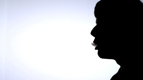 Silhouette-of-smoking-man-on-white-background