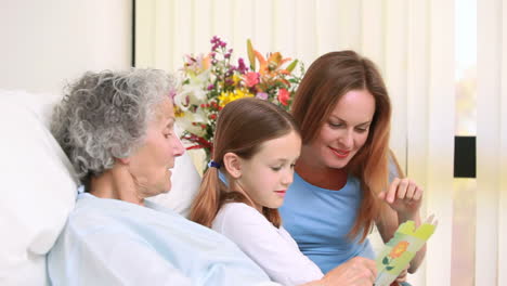 Woman-and-girl-standing-next-to-a-hospital-bed