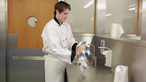 Cook-washing-and-drying-his-hands-with-a-towel