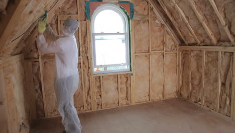 Builder-in-protecive-suit-insulating-house