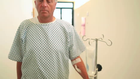 Female-patient-walking-while-holding-a-drip-stand