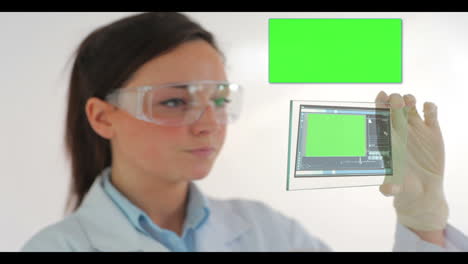 Scientist-in-protective-clothes-watching-holographic-chroma-keys