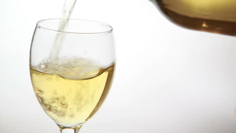 Glass-being-filled-with-white-wine