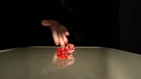 Hand-throwing-two-red-dice