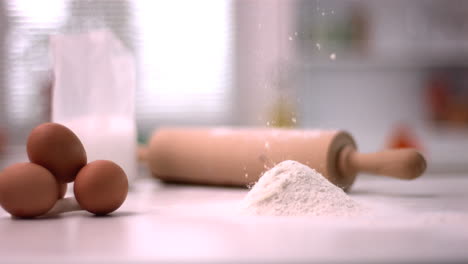 Flour-sprinking-on-kitchen-counter-with-baking-tools
